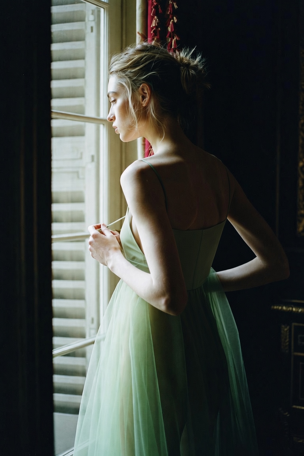 The Sheer Layer — a lined green sheer tulle midi dress worn with black heeled sandals in a Paris hotel room, the ESVRA Most Wanted edit on how to wear sheer for fall 2026