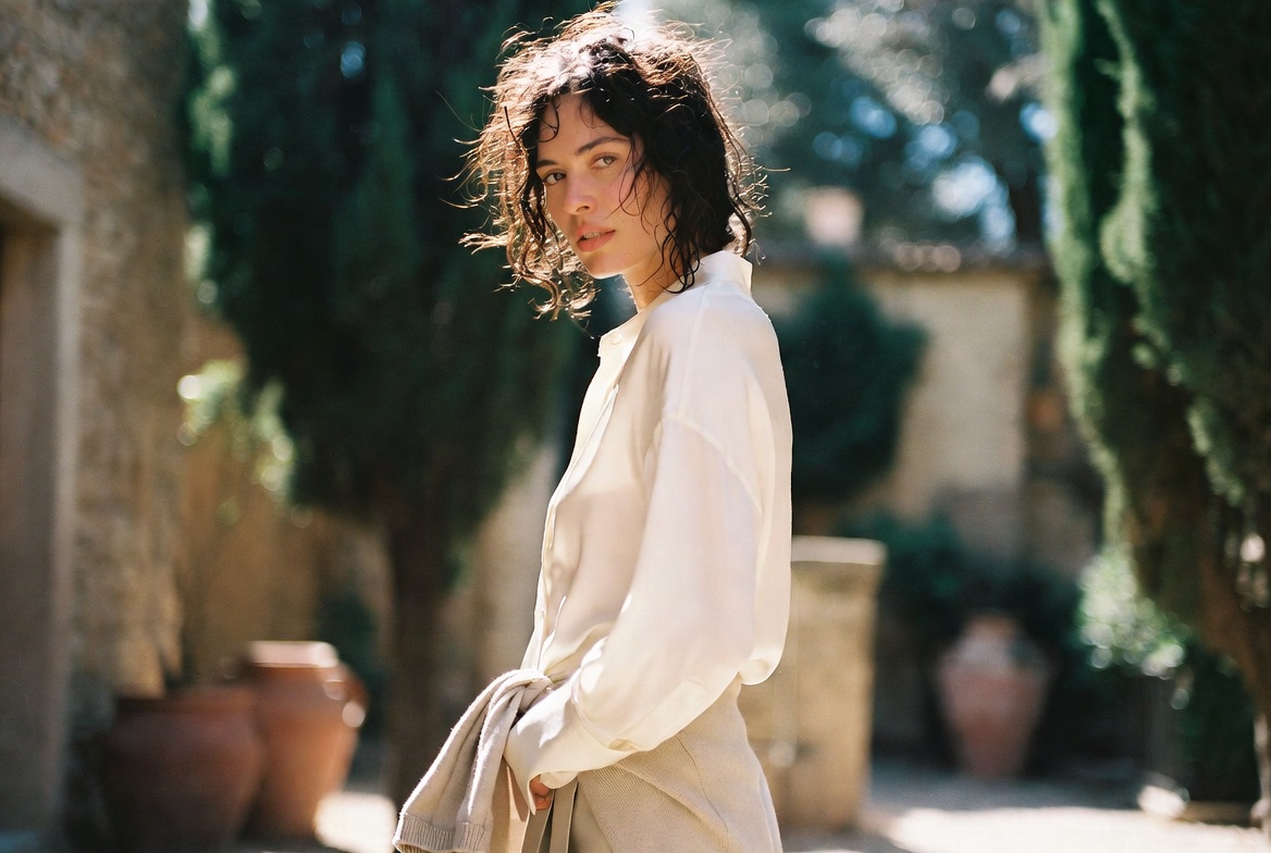 A model in a quiet luxury summer look in a Mediterranean garden